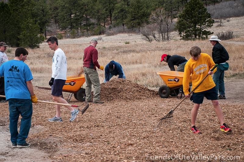 Volunteers raking mulch